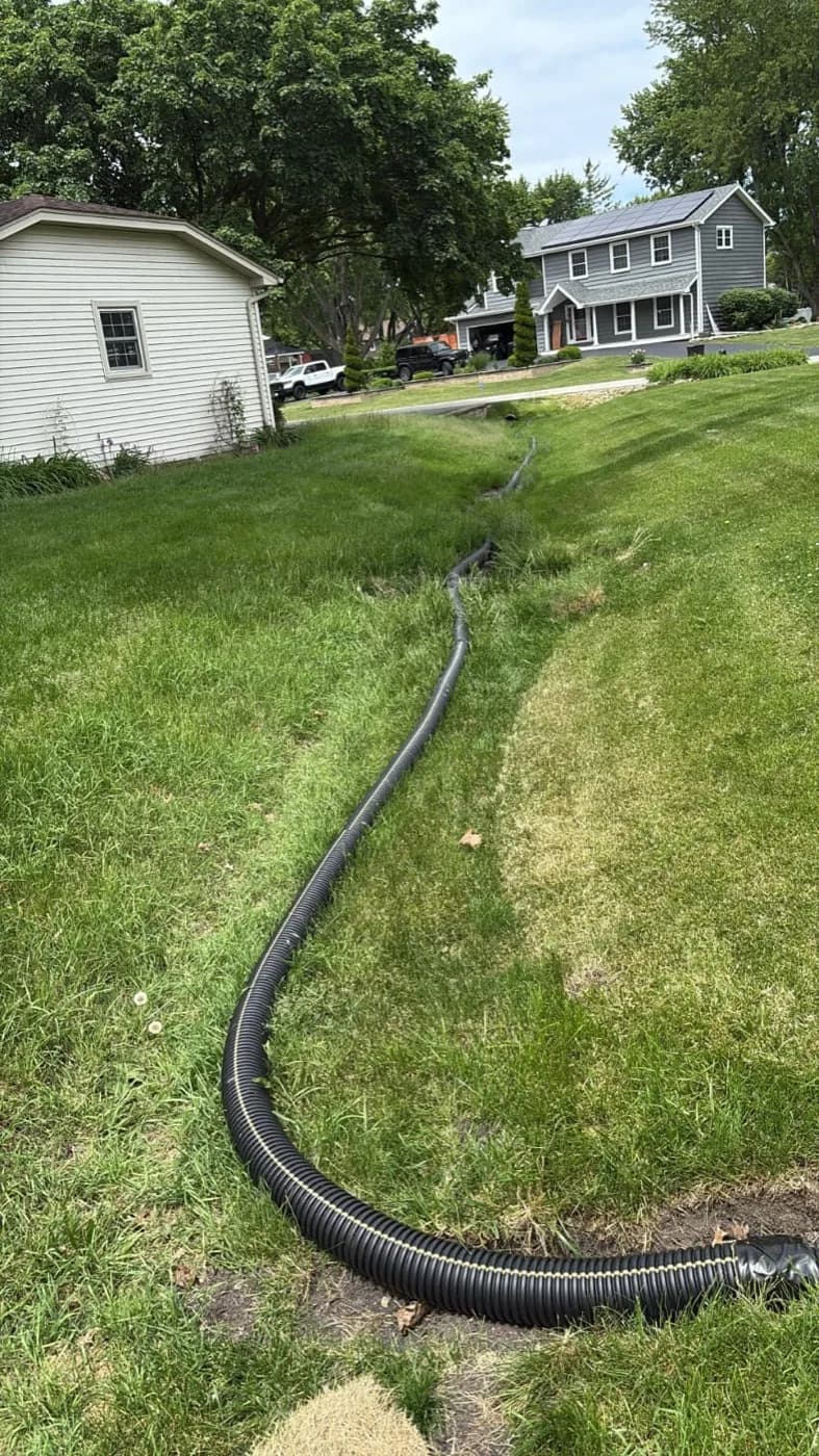 Downspout drain line run out to daylight between two houses