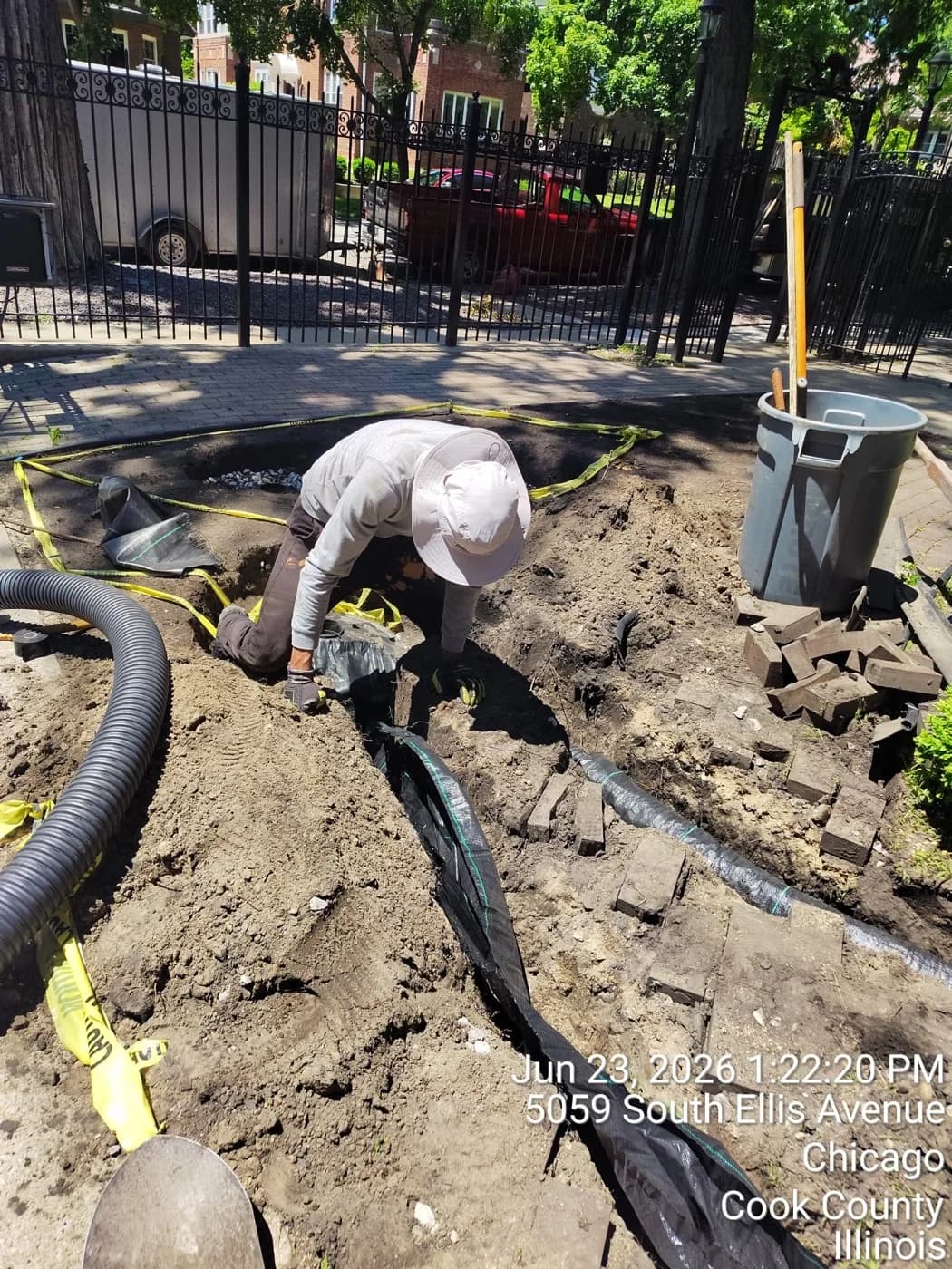 Crew member setting a catch basin in a city front yard