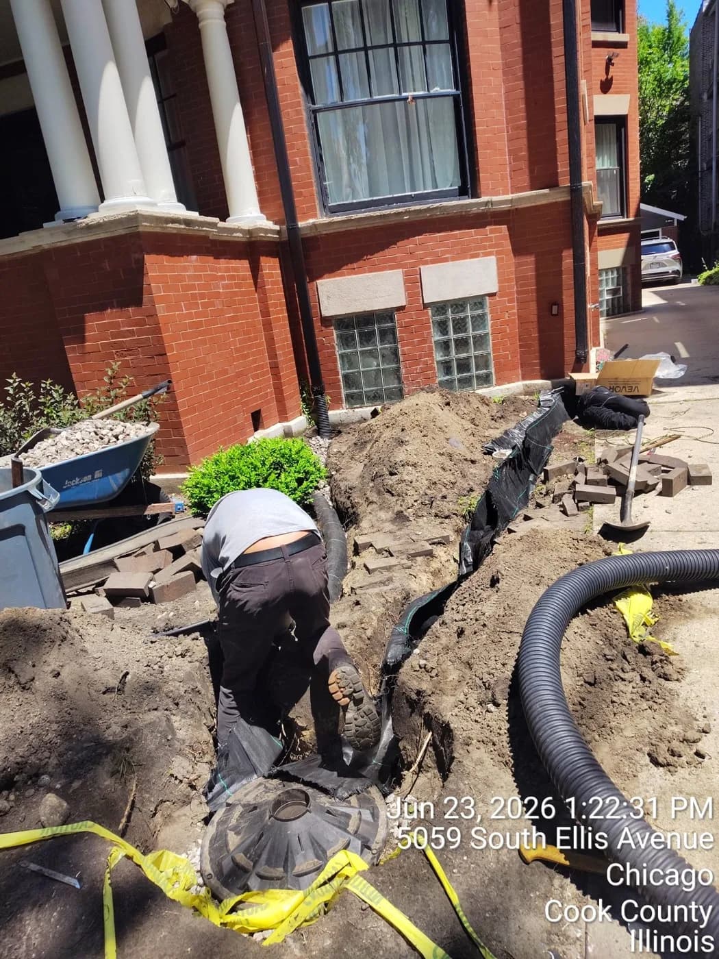 Downspout run dug in tight along a foundation to carry roof water away