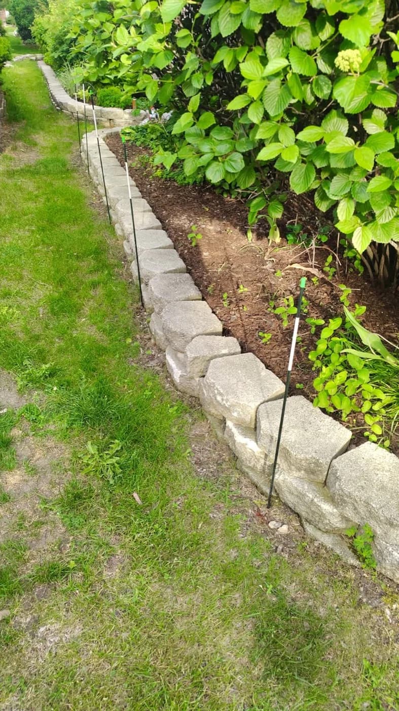 Stacked stone edging holding a freshly turned shade bed